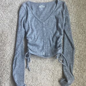 Ribbed, light weight top, v neck, buttons down the front with ruched sides